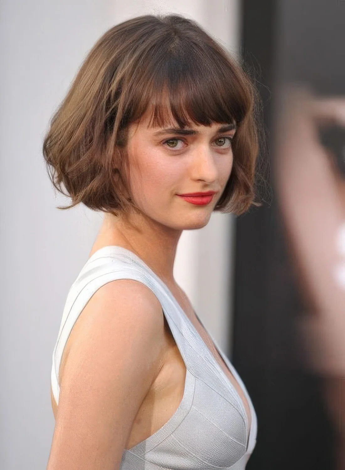 Ear-length brunette bob with a classic fringe, waves and curved ends screams Parisian chic.