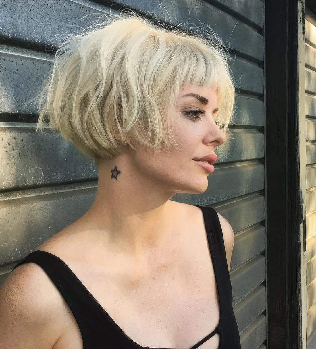 Short blonde messy ear-length bob with a classic fringe and dimension.
