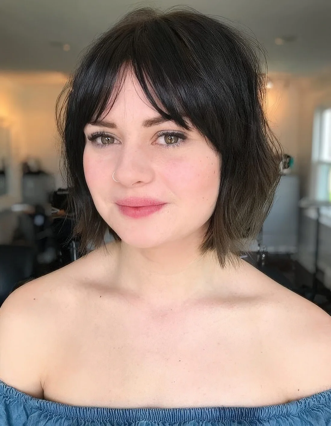 Messy and textural brown bob with layered and bottleneck bangs.