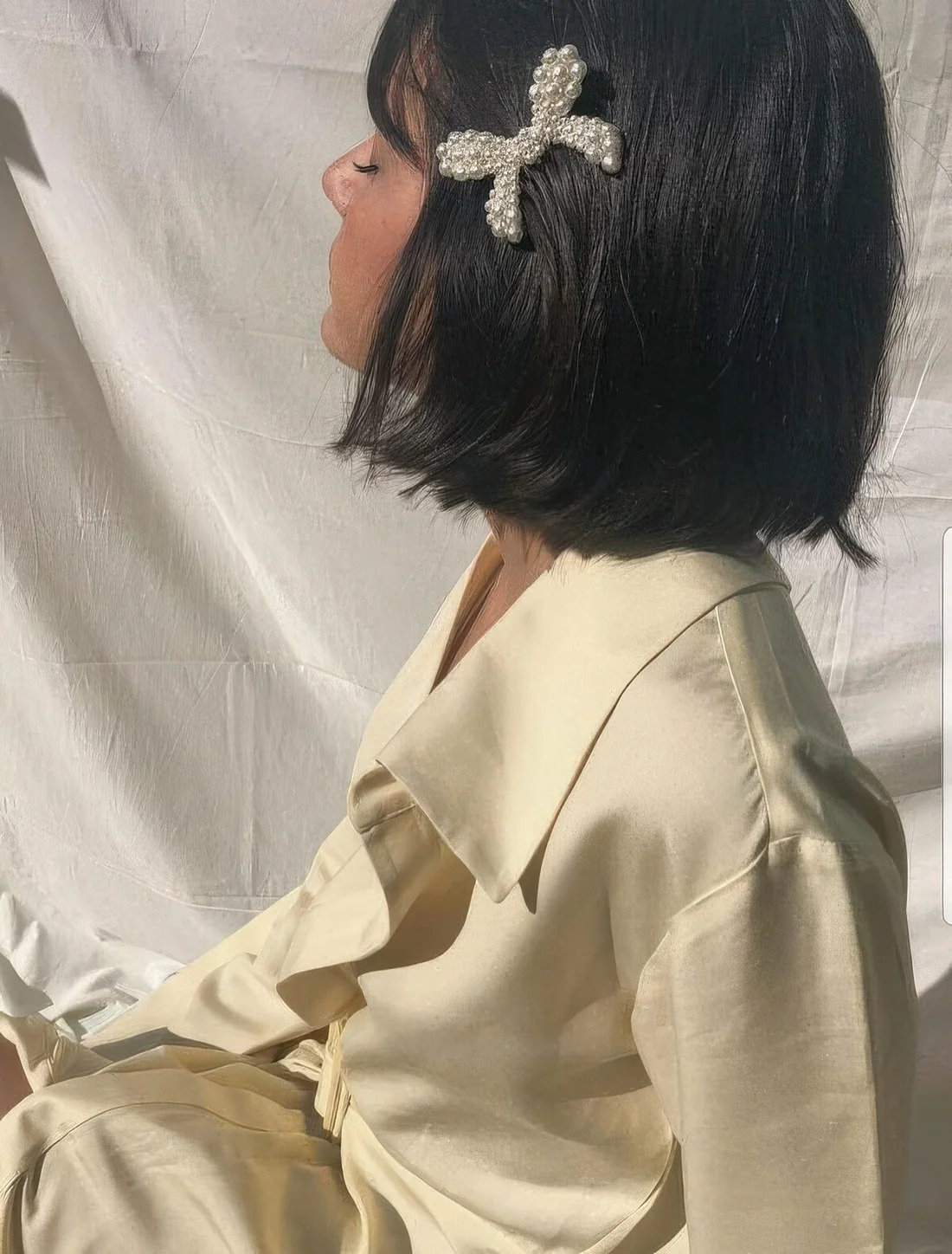 Photo showing little pearl bow, with the hairstyle clearly visible.
