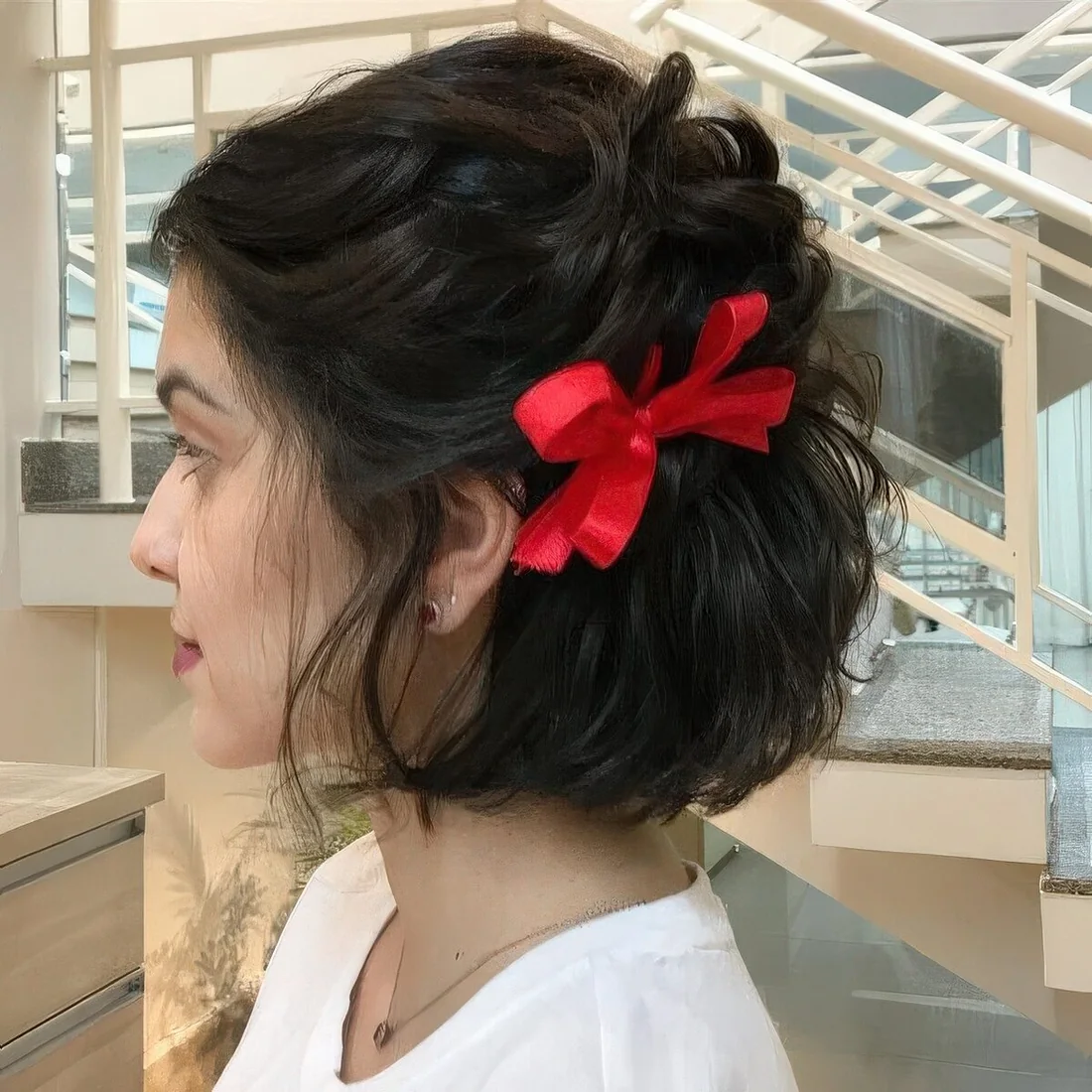 Photo showing red bow on side, with the hairstyle clearly visible.