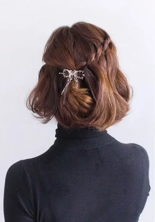 Photo showing rhinestone bow, with the hairstyle clearly visible.