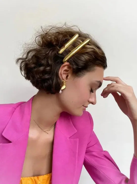 Photo showing statement polished gold, with the hairstyle clearly visible.