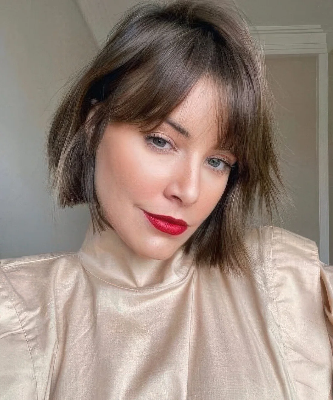 Brunette bob bob with bottleneck bangs and a bit of texture.
