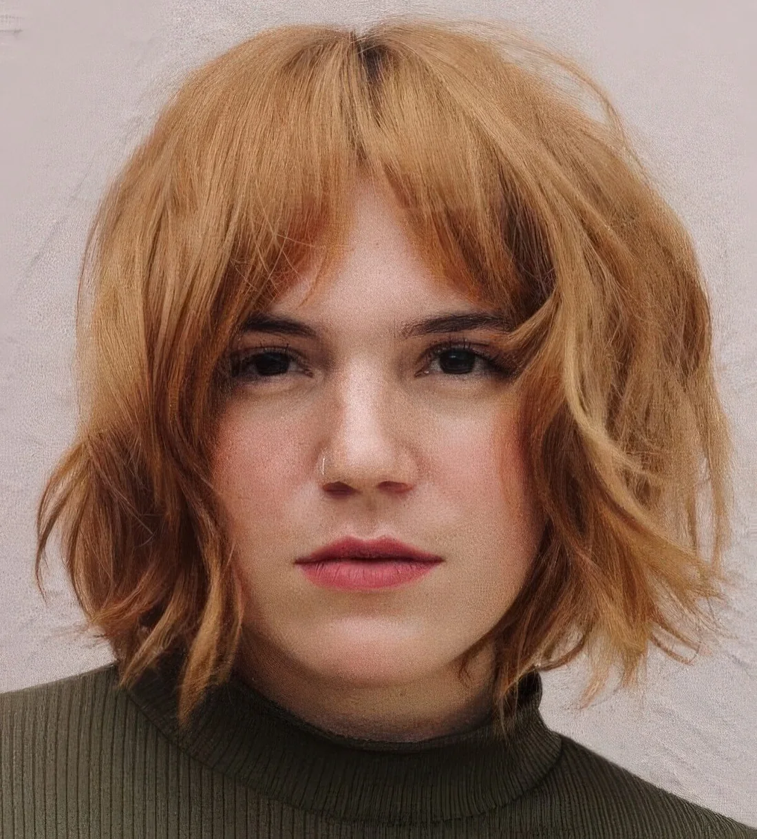 Ginger textured bob with shaggy layers and bottleneck bangs.