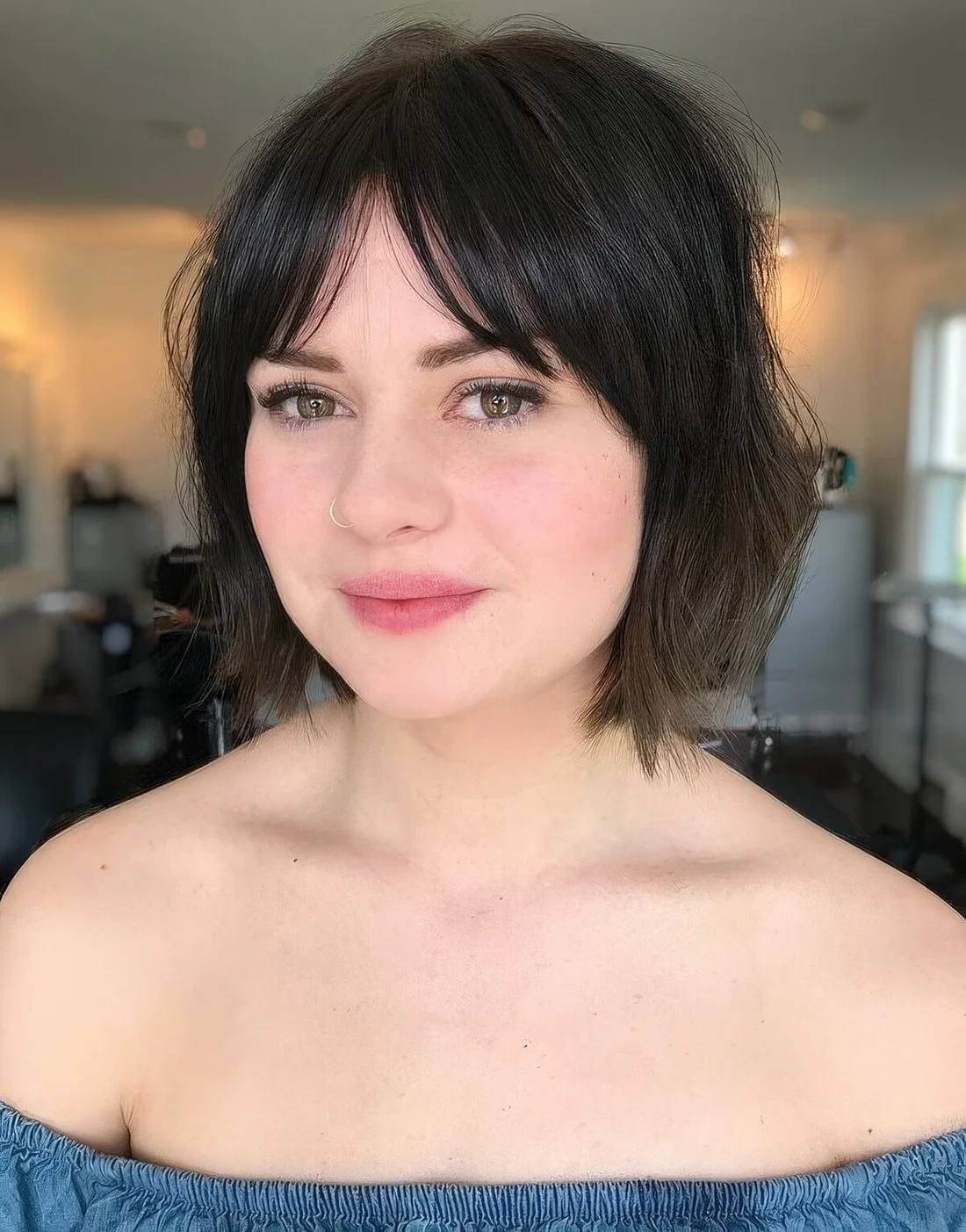 Messy and textural brown bob with layered and bottleneck bangs.