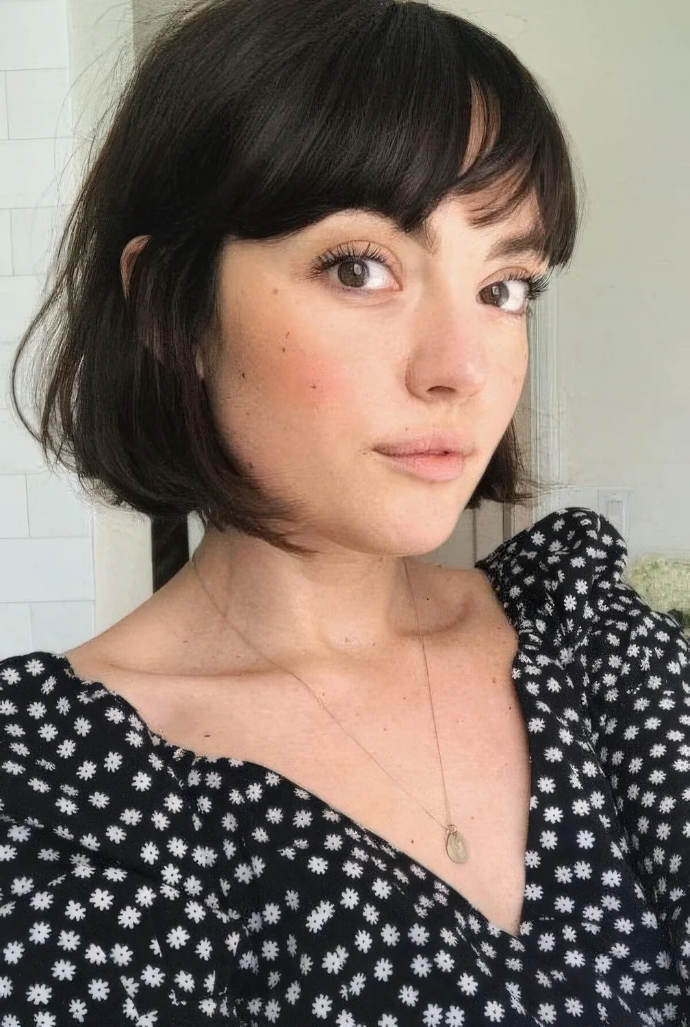 Almost black French bob with wispy and bottleneck bangs.