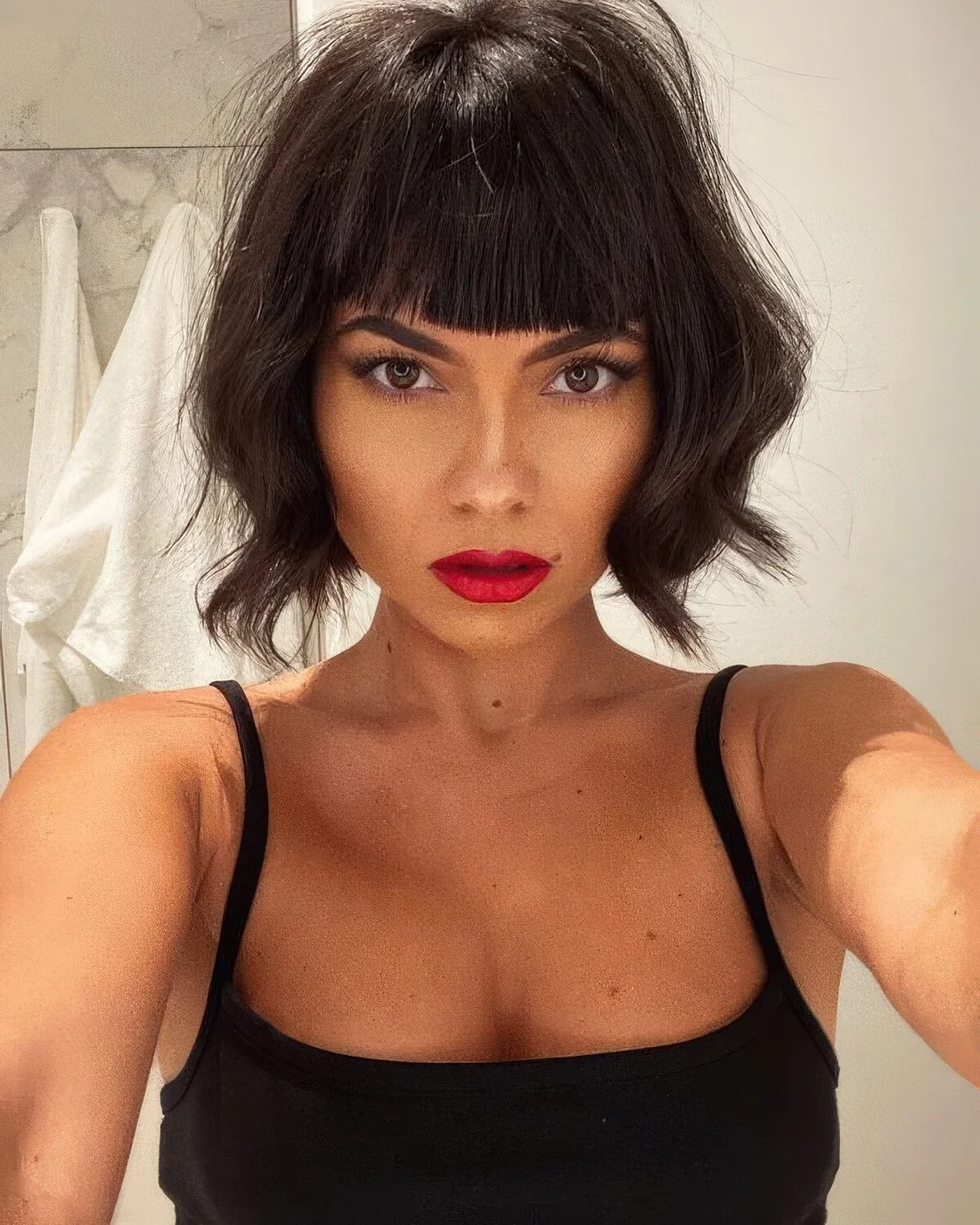 Photo showing angled wavy bob, with the hairstyle clearly visible.