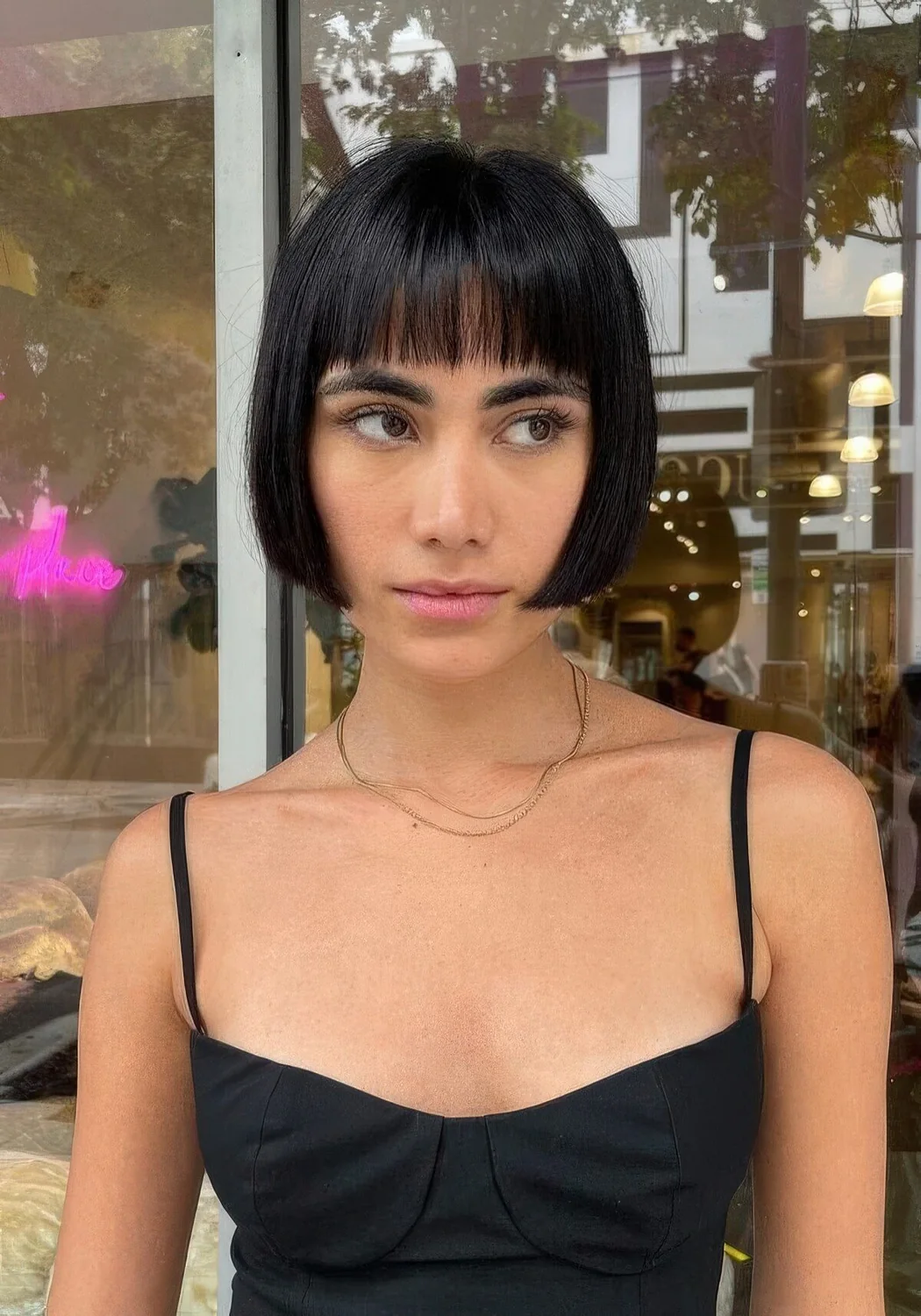 Photo showing black jaw-length bob, with the hairstyle clearly visible.