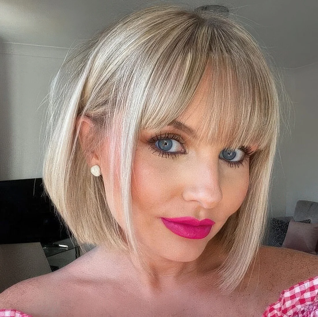 Photo showing blonde bob with fringe, with the hairstyle clearly visible.
