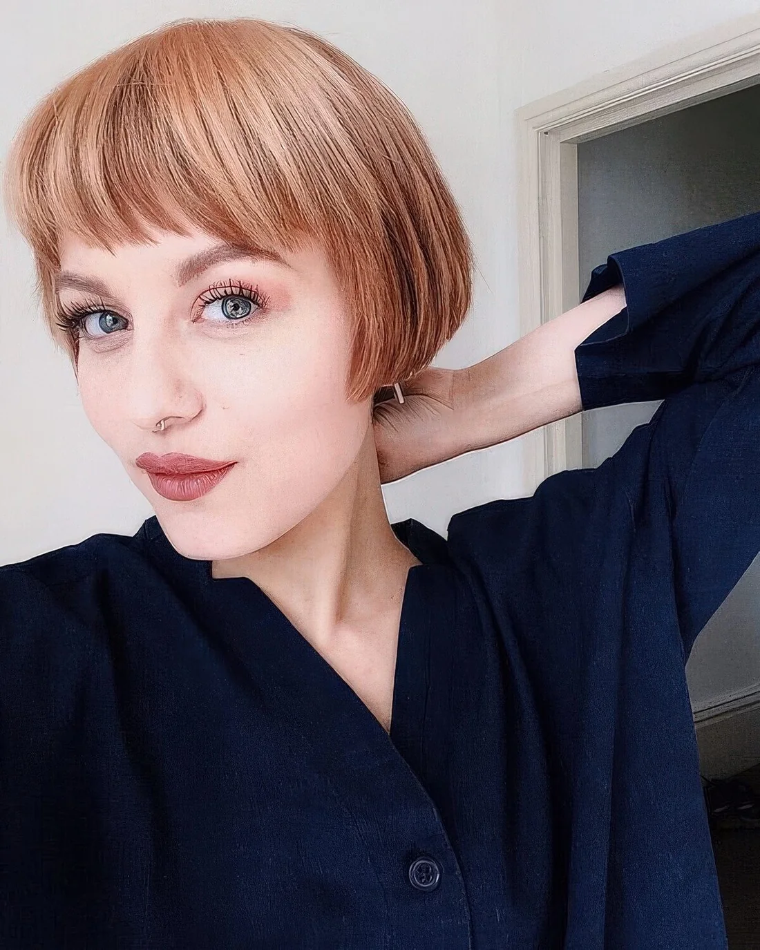 Photo showing ginger ear-length bob, with the hairstyle clearly visible.