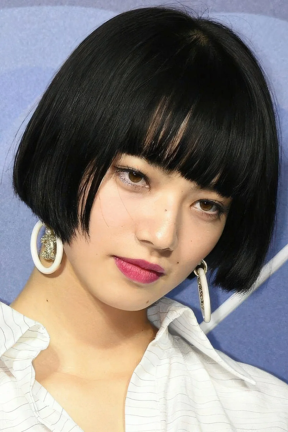 Photo showing sleek black ear-length bob, with the hairstyle clearly visible.