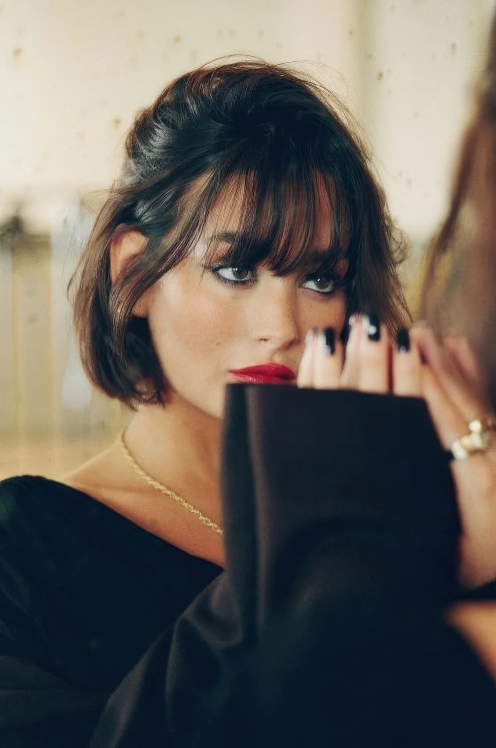Messy hairstyle with outgrown bangs.