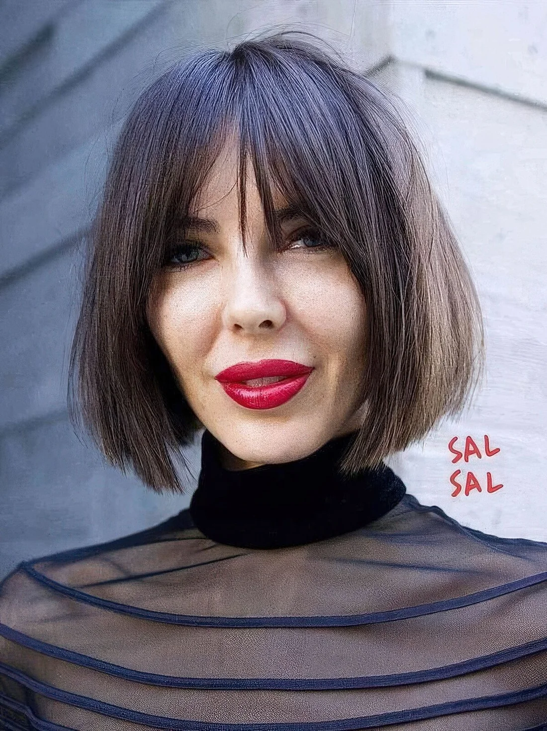 Dark brown chin-length bob with wispy bangs and plenty of texture and volume.