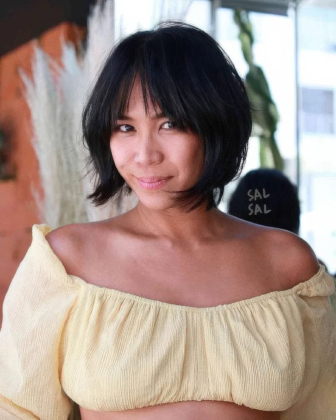 Black jaw-length bob with wispy and bottleneck bangs plus curved ends.