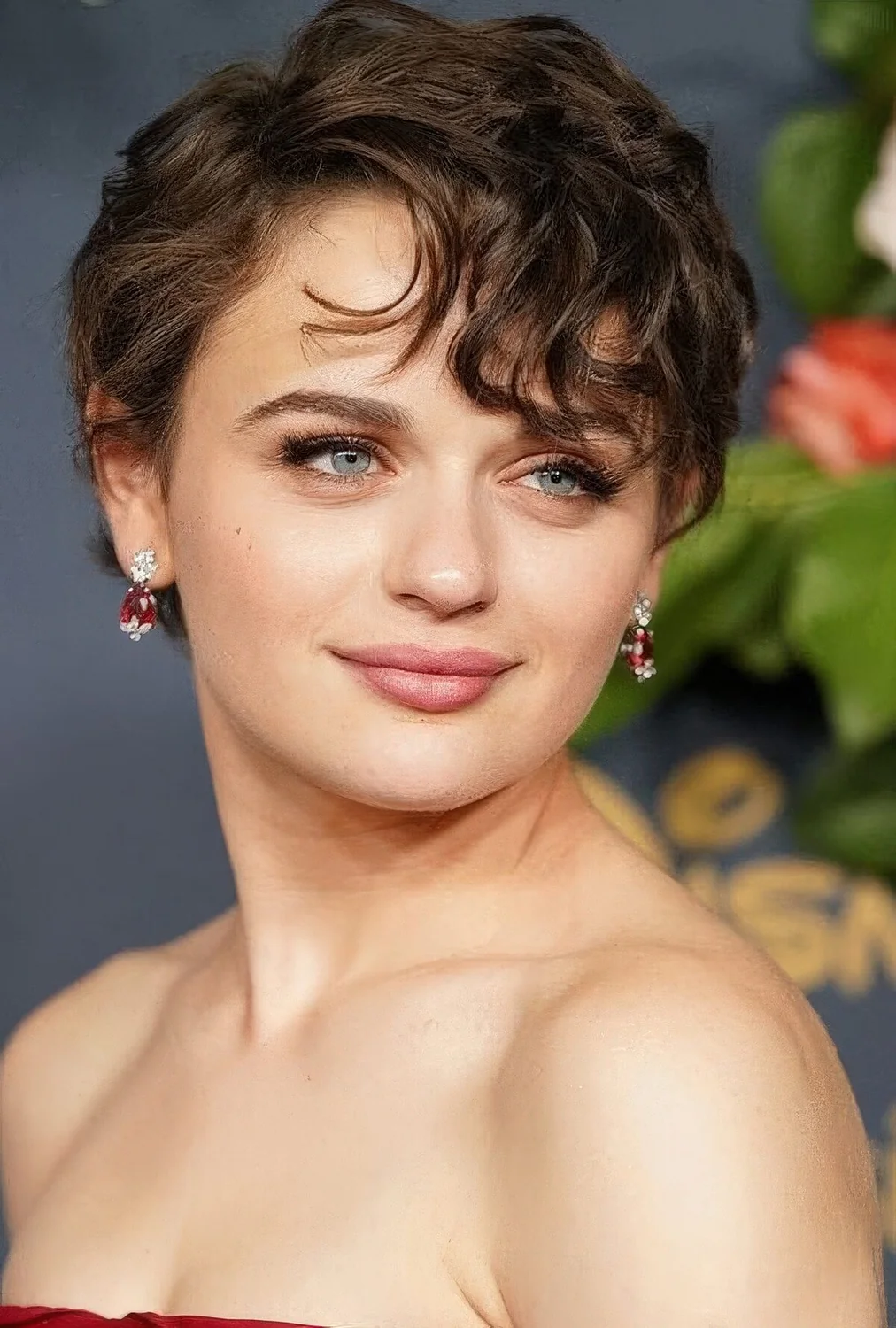 Brown wavy bixie with side part, long side bangs.