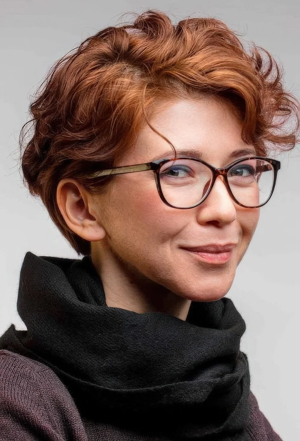 Ginger wavy pixie with short side bangs.