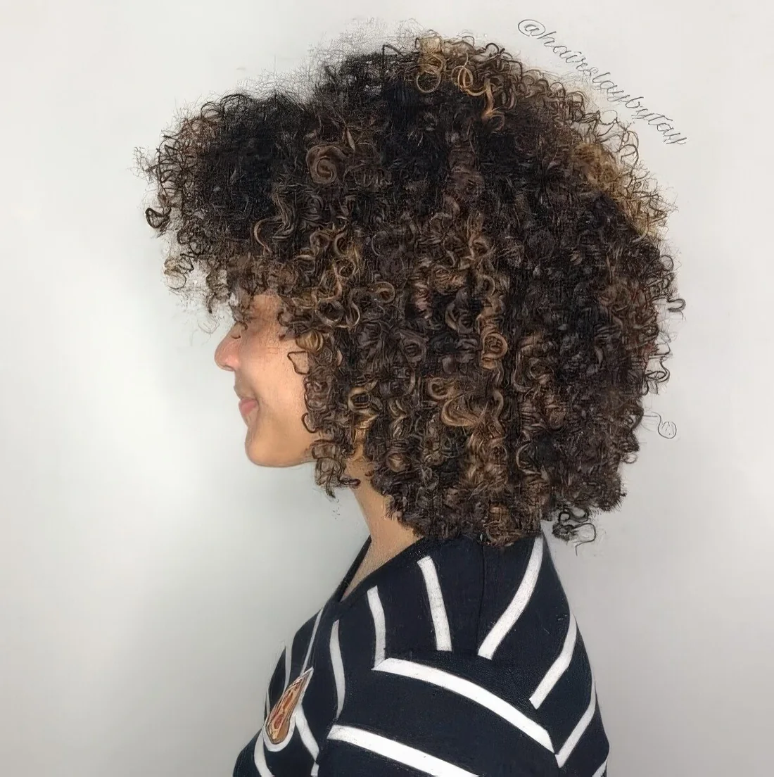 Rounded bob shape with a trendy bang and fun layers.