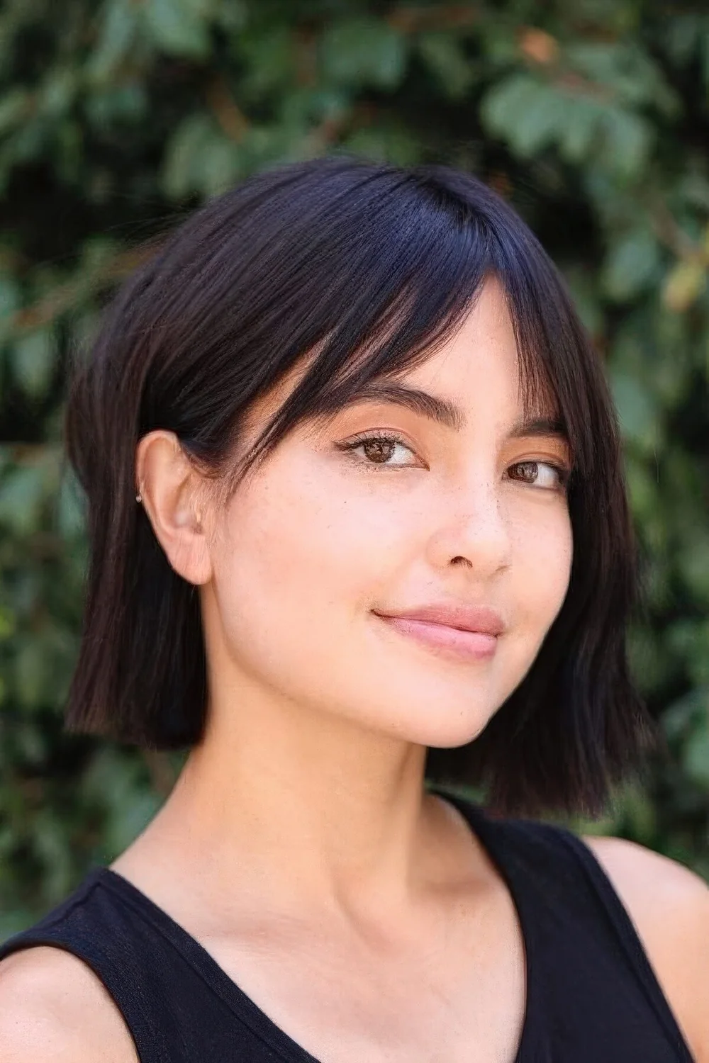 Dark brown, almost black bob with short curtain bangs.