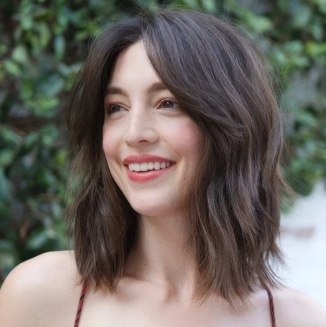 Long shaggy brown bob with short curtain bangs to accent the face.