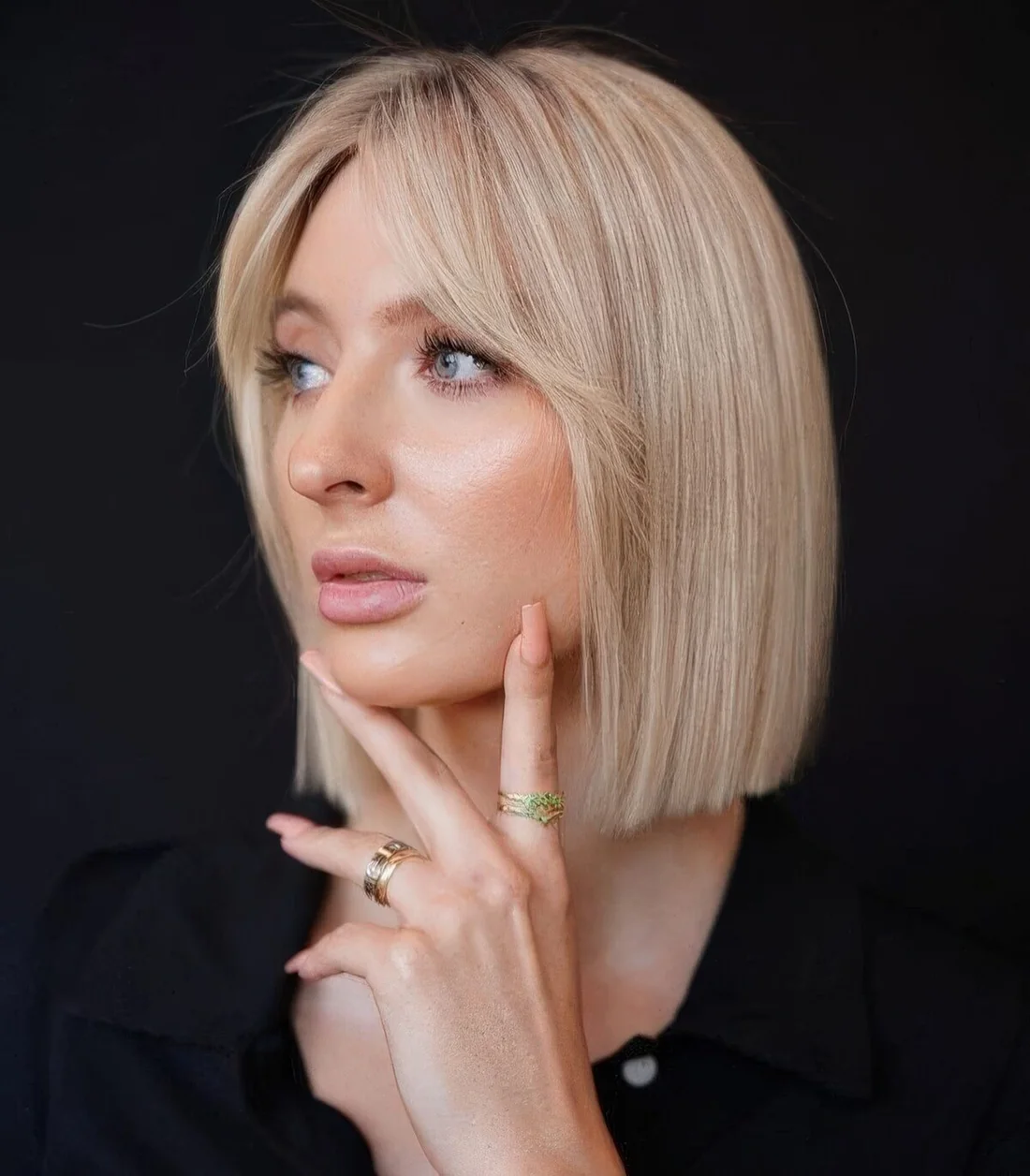 Refined icy blonde blunt bob with short curtain bangs.