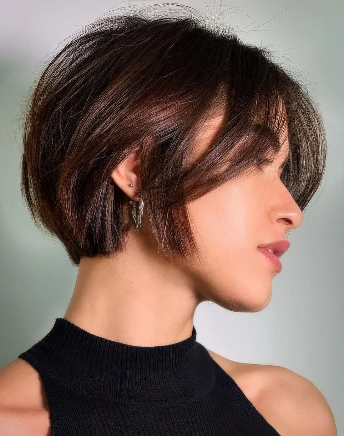 Short and textural bob with bangs in a beautiful chestnut shade.