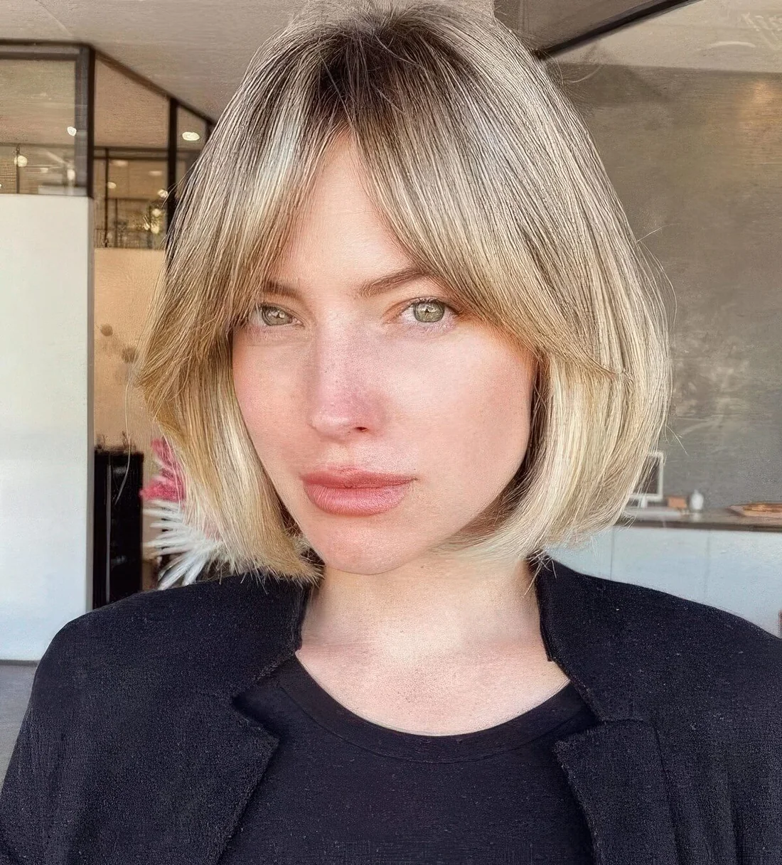 Blonde short bob with curtain bangs.