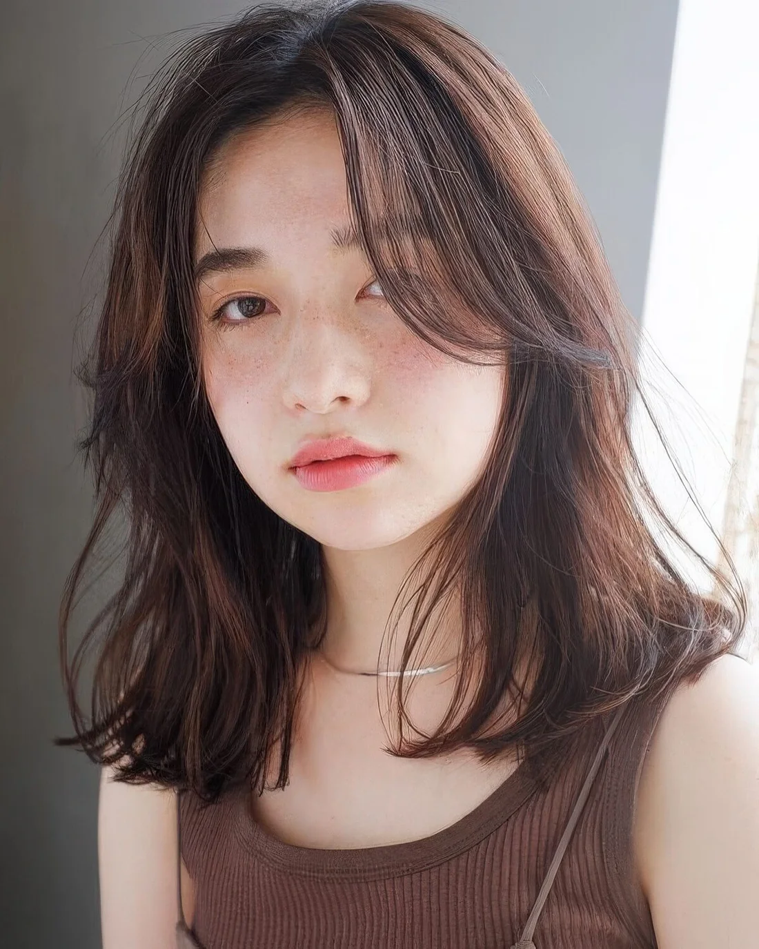 Brunette medium-length locks with texture and curtain bangs are amazing and look very relaxed and cool.