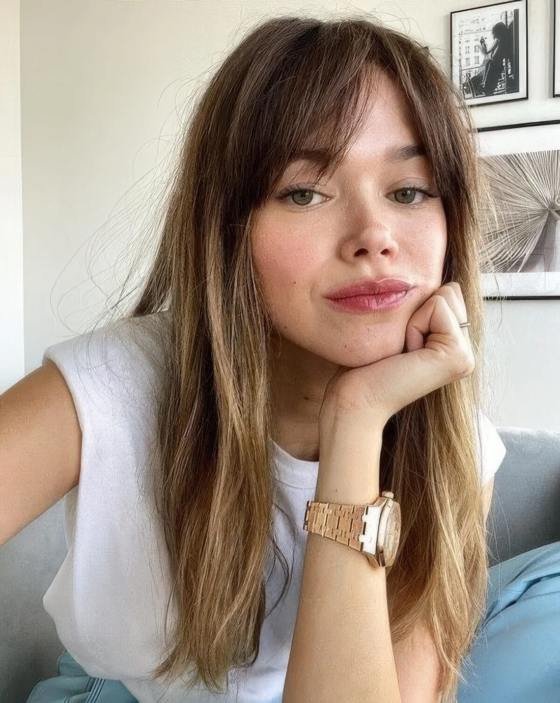 Long brown hair with honey blonde balayage and curtain bangs plus texture.
