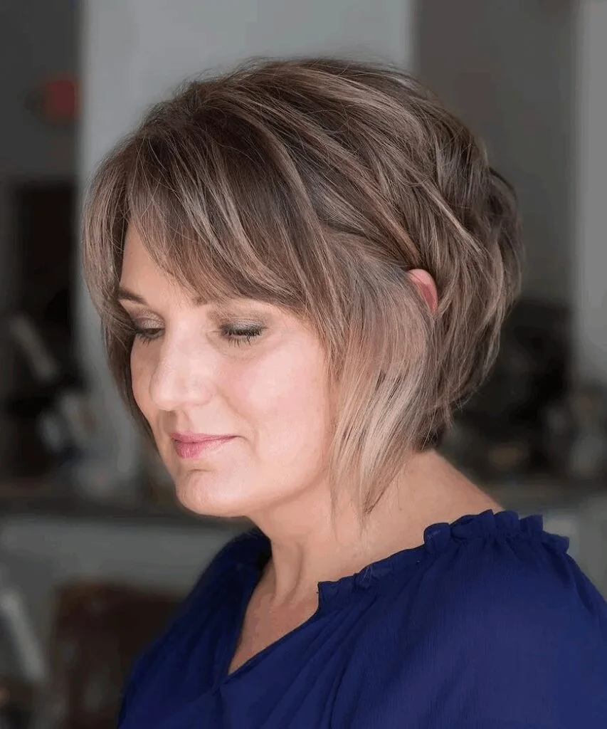 neck wavy chestnut shag with wispy fringe shown as a short fine hairstyles for women in their 40s idea