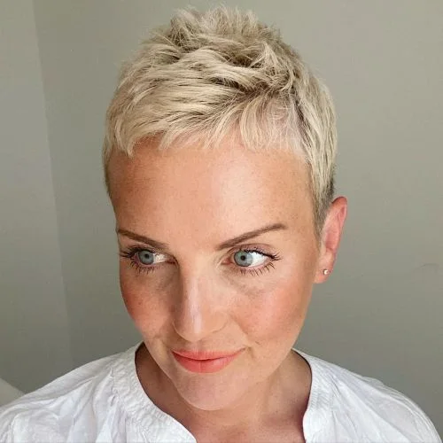 ear straight honey pixie with micro fringe shown as a short fine hairstyles for women in their 40s idea