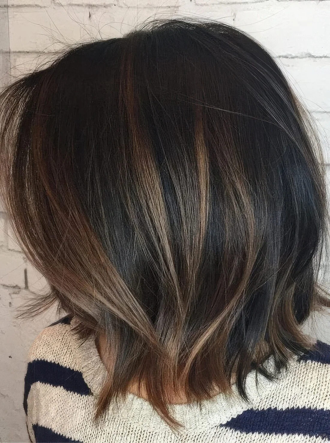 Black bob with caramel balayage and babylights.
