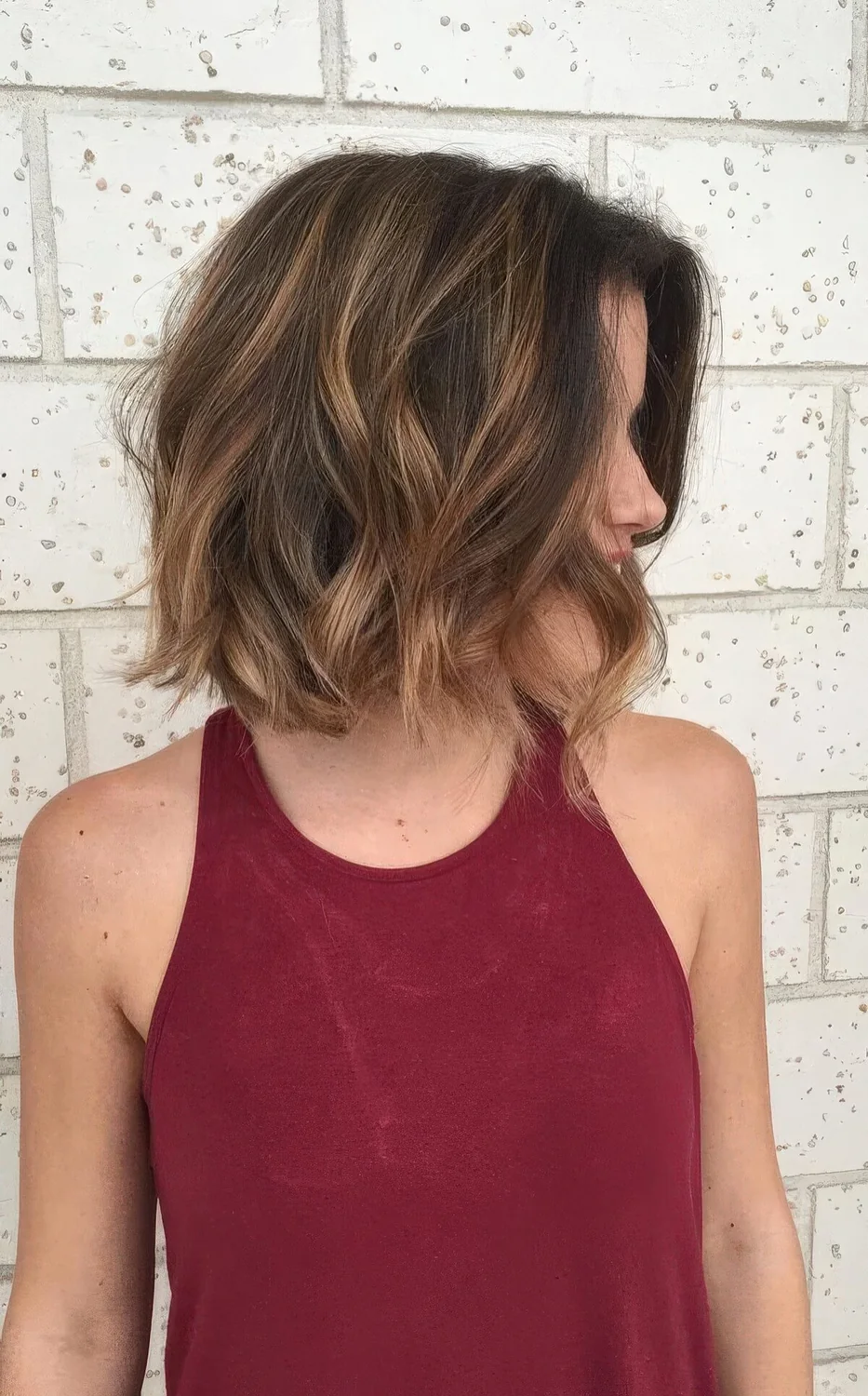 Black bob with caramel balayage and waves.
