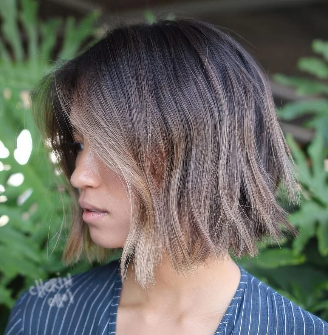Choppy bob with darker root and bronde and blonde balayage, with texture and volume.