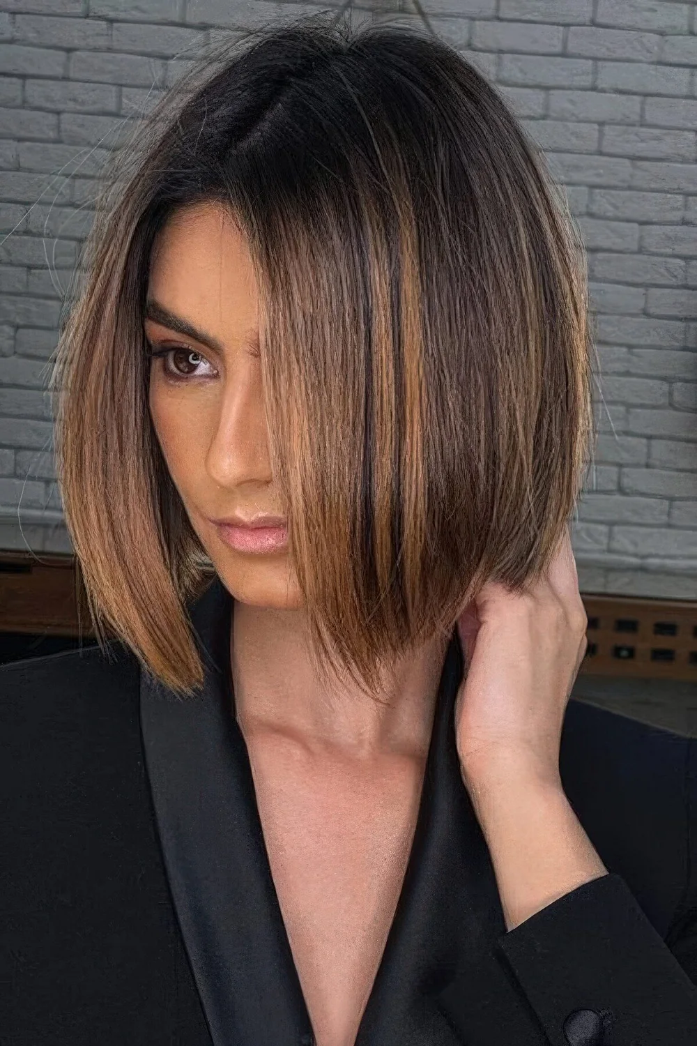 Dark brown bob with a darker root and caramel balayage.