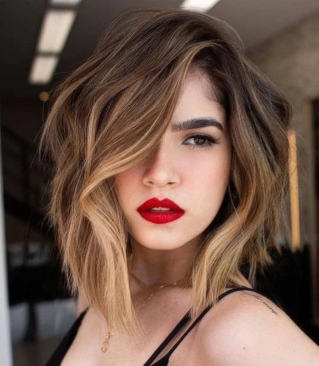 Dark brown bob with blonde and bronde balayage and a money piece to highlight the face.