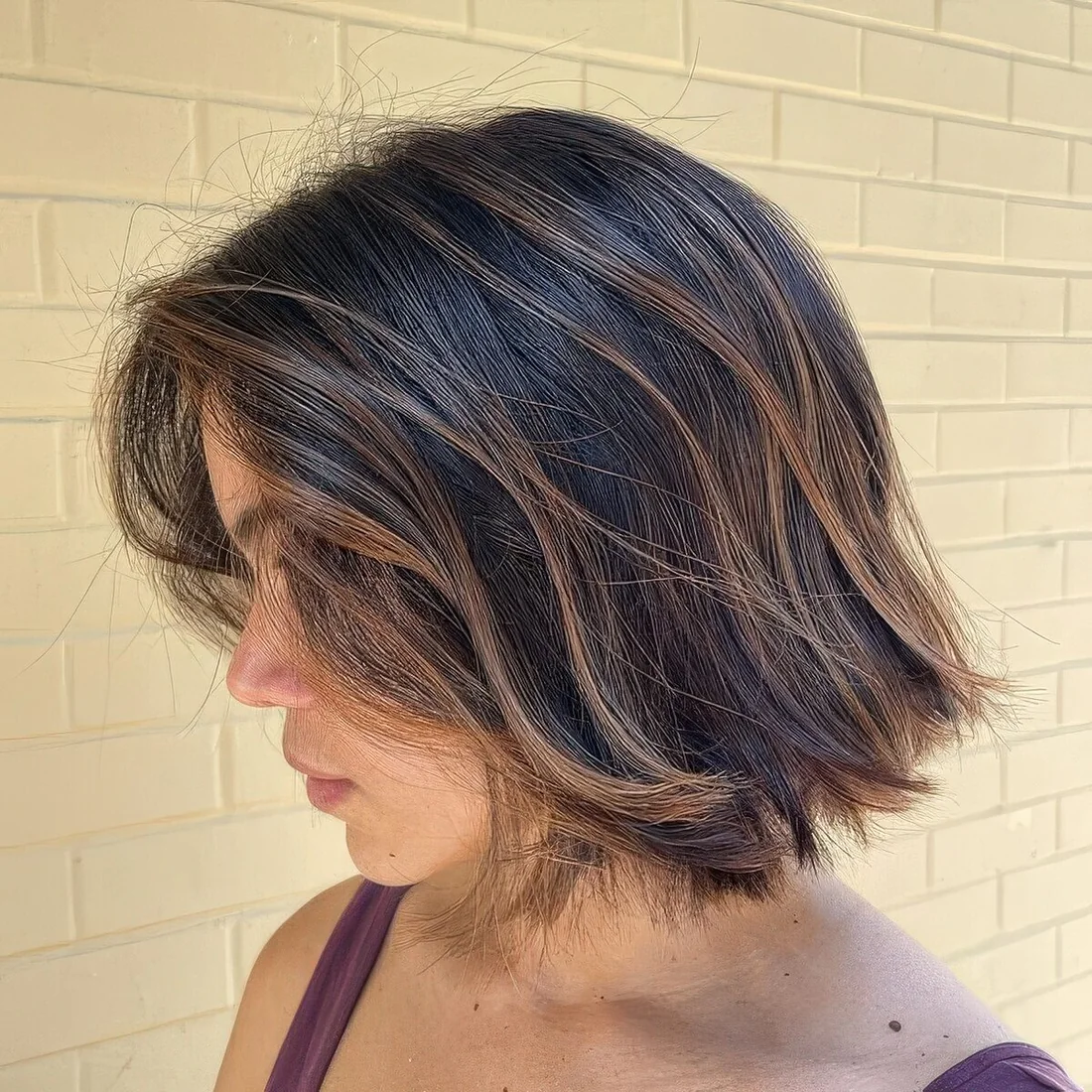 Dark textural bob with caramel balayage and babylights.