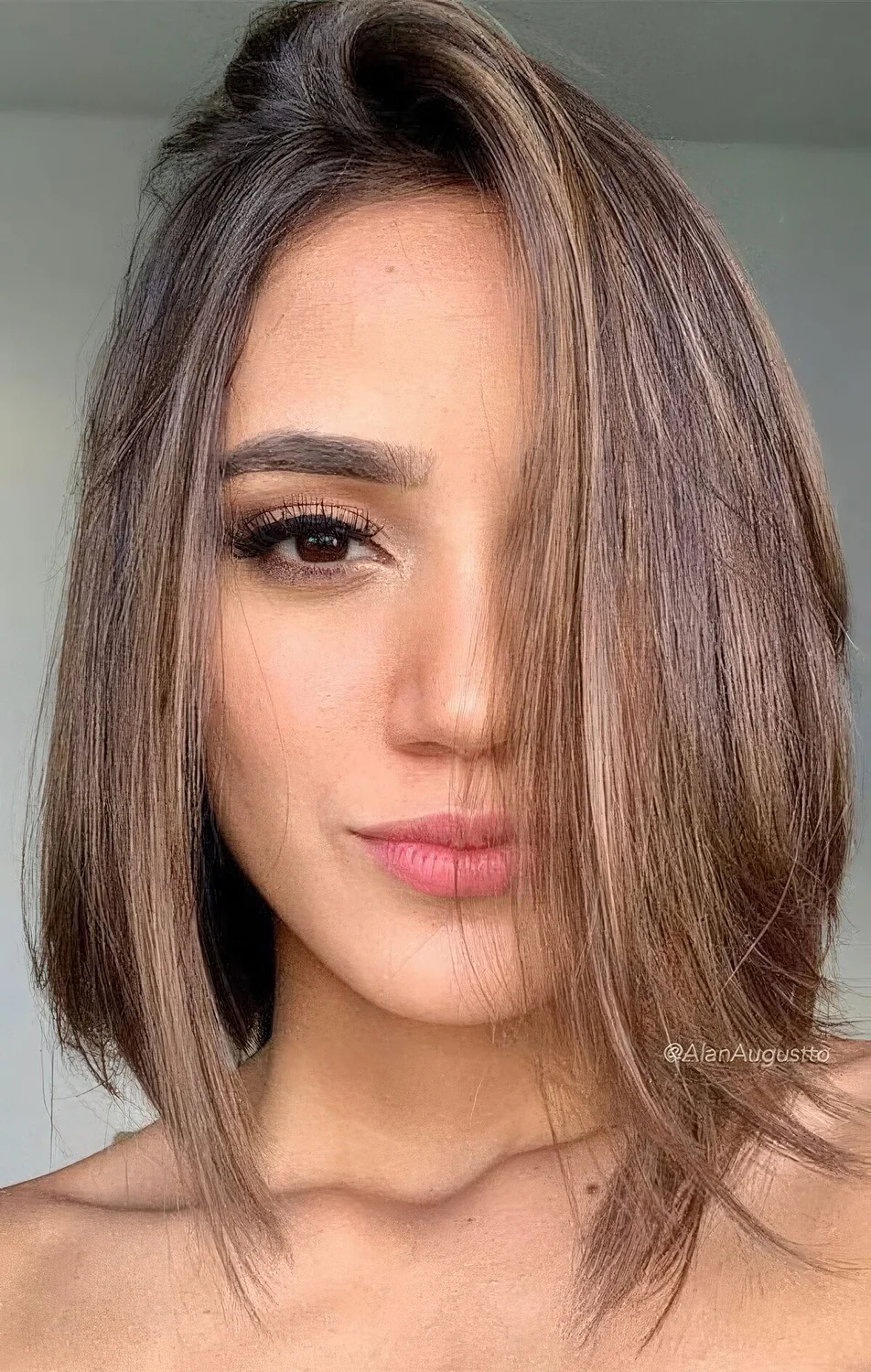 Dark brown bob with caramel and gold balayage, with a bit of texture and much volume.