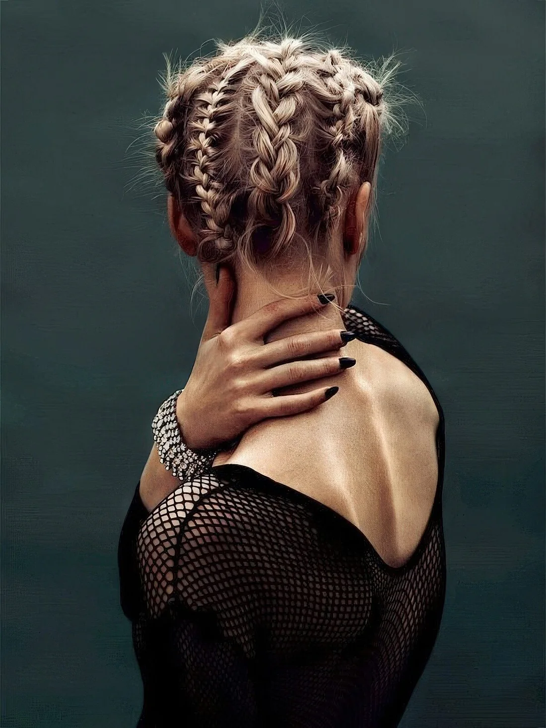 Short blonde hair fully braided and secured on the top.