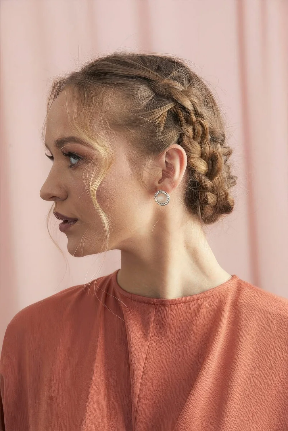 Short braided updo with some hair framign the face.