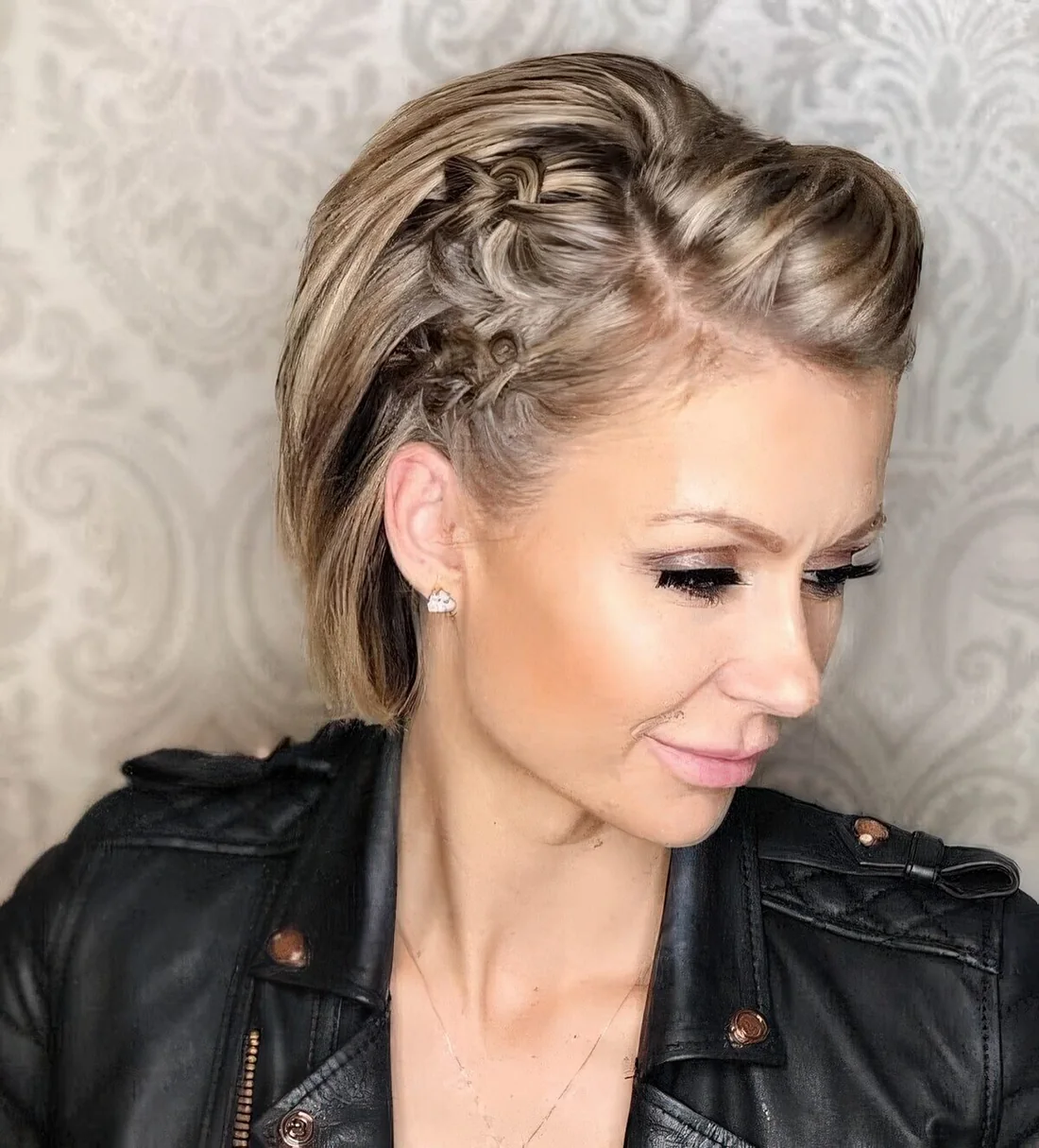 Jaw-length bob accented with a bit of braided elements and with some volume on top.