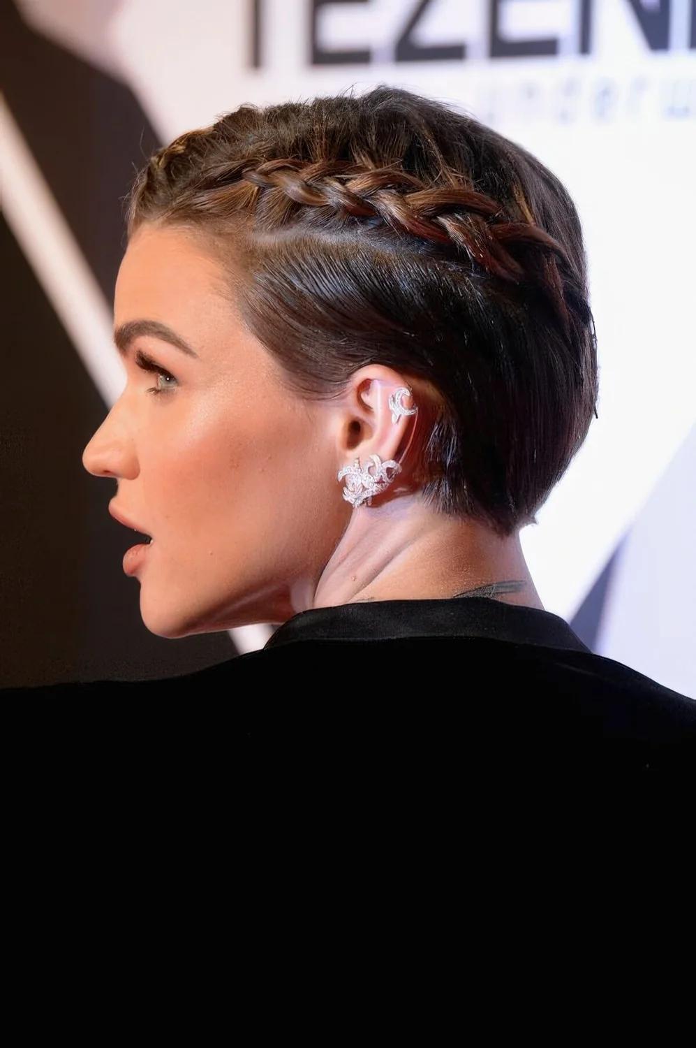 Brunette pixie styled with a single side braid.
