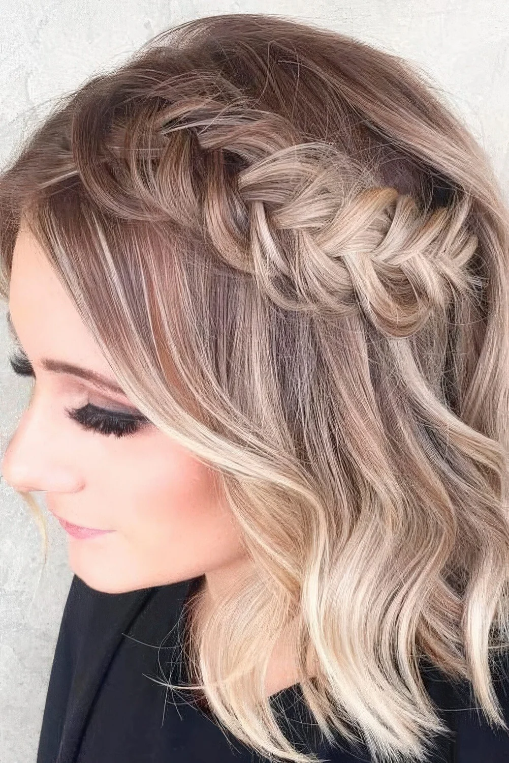 Chic half updo with a loose braid and hair down.