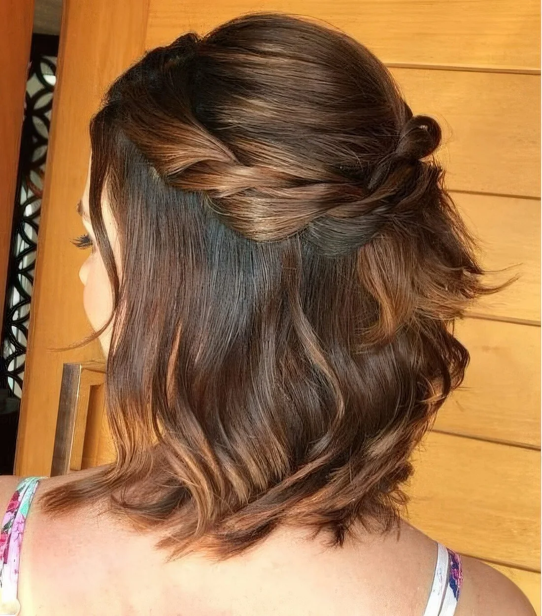 Simple and lovely half updo with a bump on top and a braided halo plus some hair down.