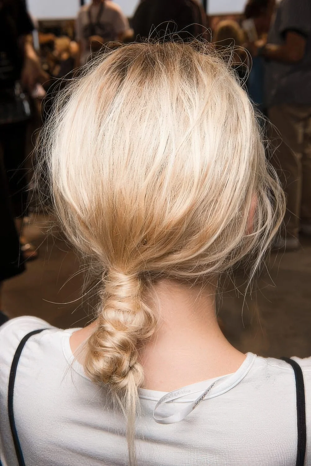 Creative wrapped ponytail with a messy top.