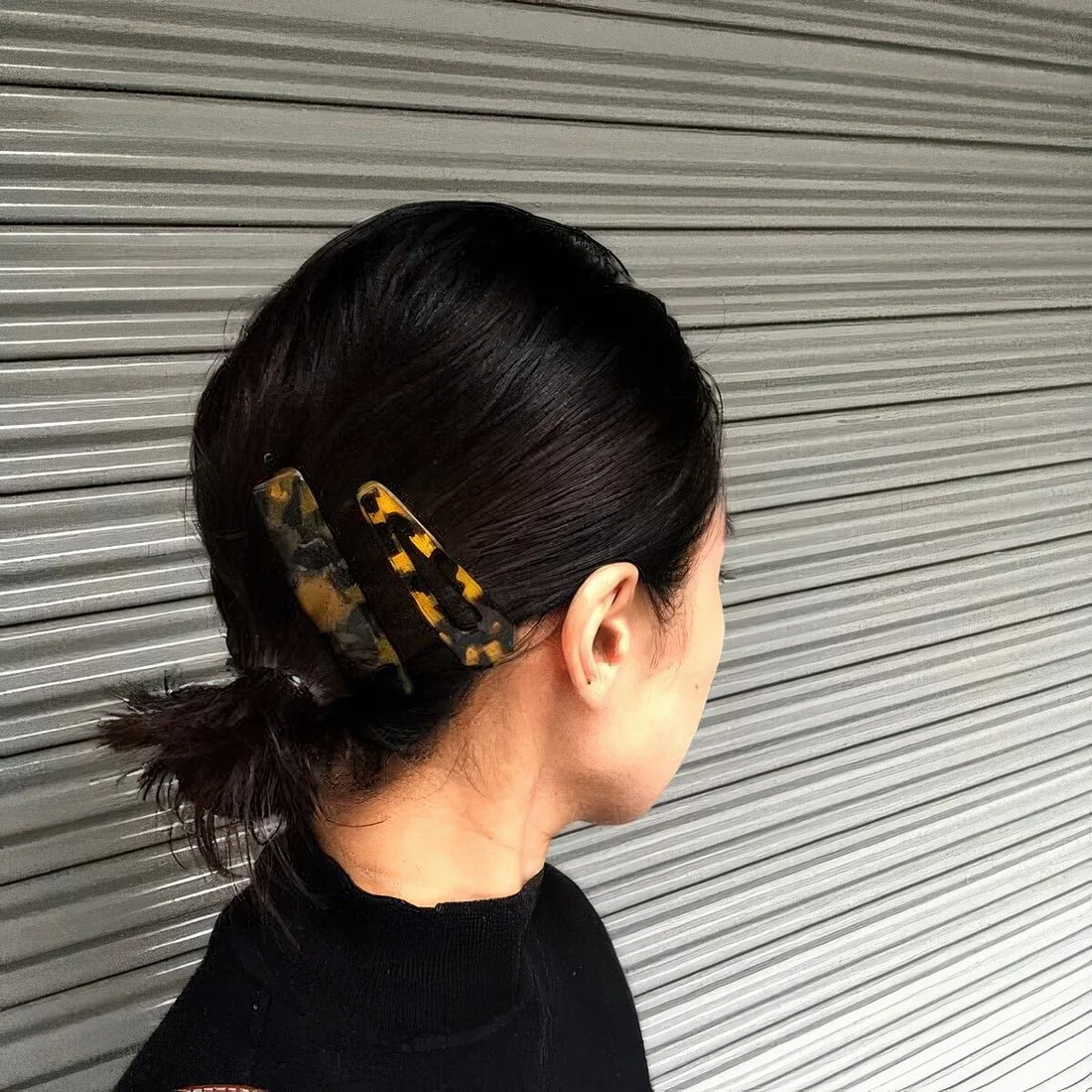 Low ponytail with hair pieces that accent the look and add color to it.