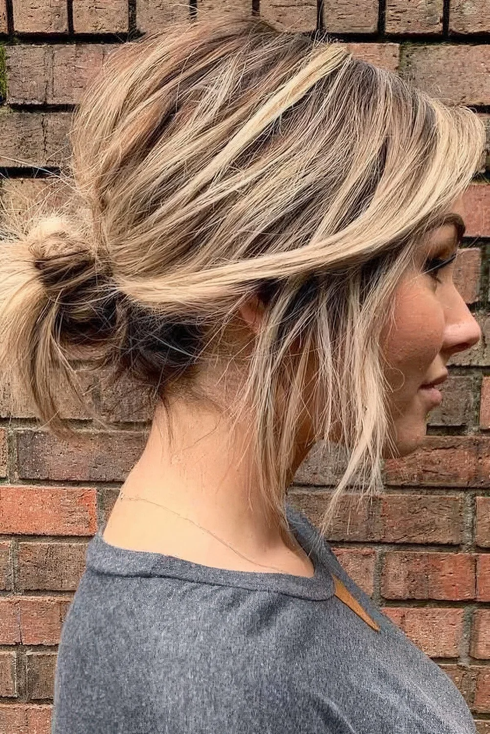 Casual updo on short hair, a low messy bun with a messy top and some hair down.