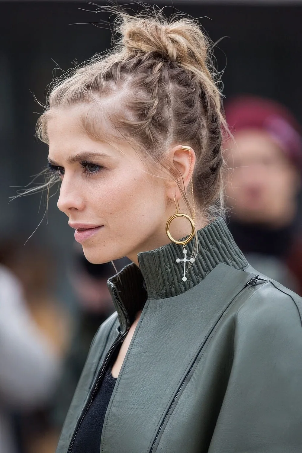 Braided updo on short hair that consists of several braids ending in a top knot.