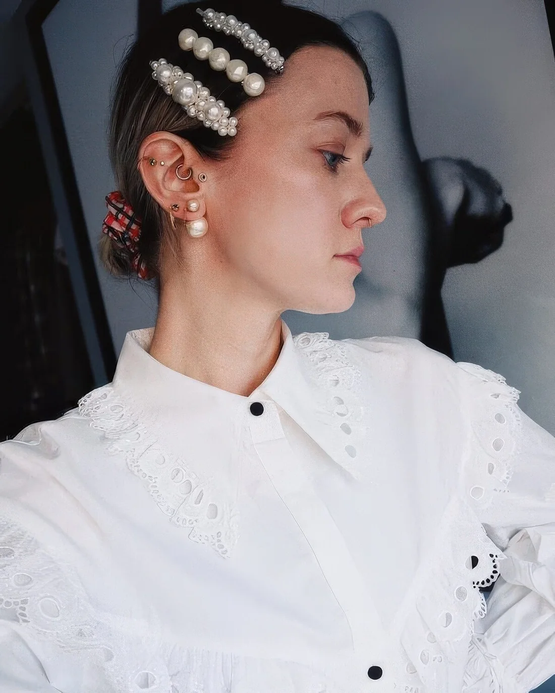 Low bun done with a plaid scrunchie and pearl hair pieces.