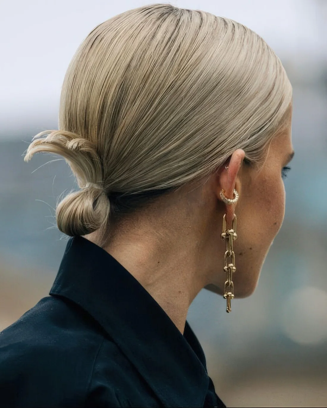 Sleek hairstyle with a low ponytail into a low bun.